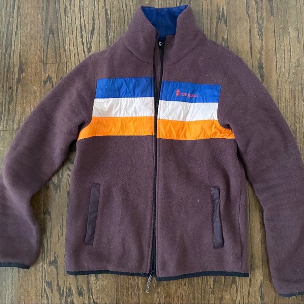 Cotopaxi Brown Fleece Jacket with Orange, Blue, and White Stripes